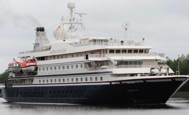 Luxury cruise ship on calm waters.
