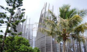 a tall building with palm trees