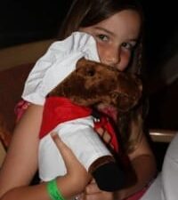 a girl holding a stuffed animal