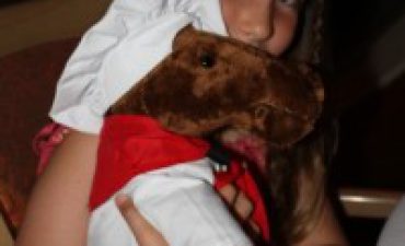 a girl holding a stuffed animal