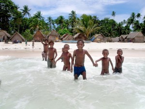 a group of children standing in the water