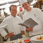 a couple of chefs in a kitchen