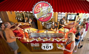 Guests aboard Carnival Breeze carry custom-made hamburgers and fries