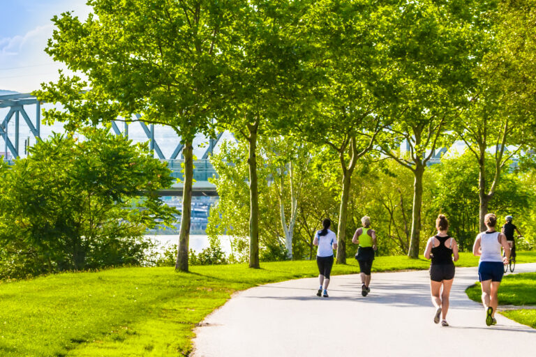 Active travellers going for a jog on the river bank