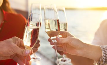 Which cruise line has the cheapest glass of wine at sea?