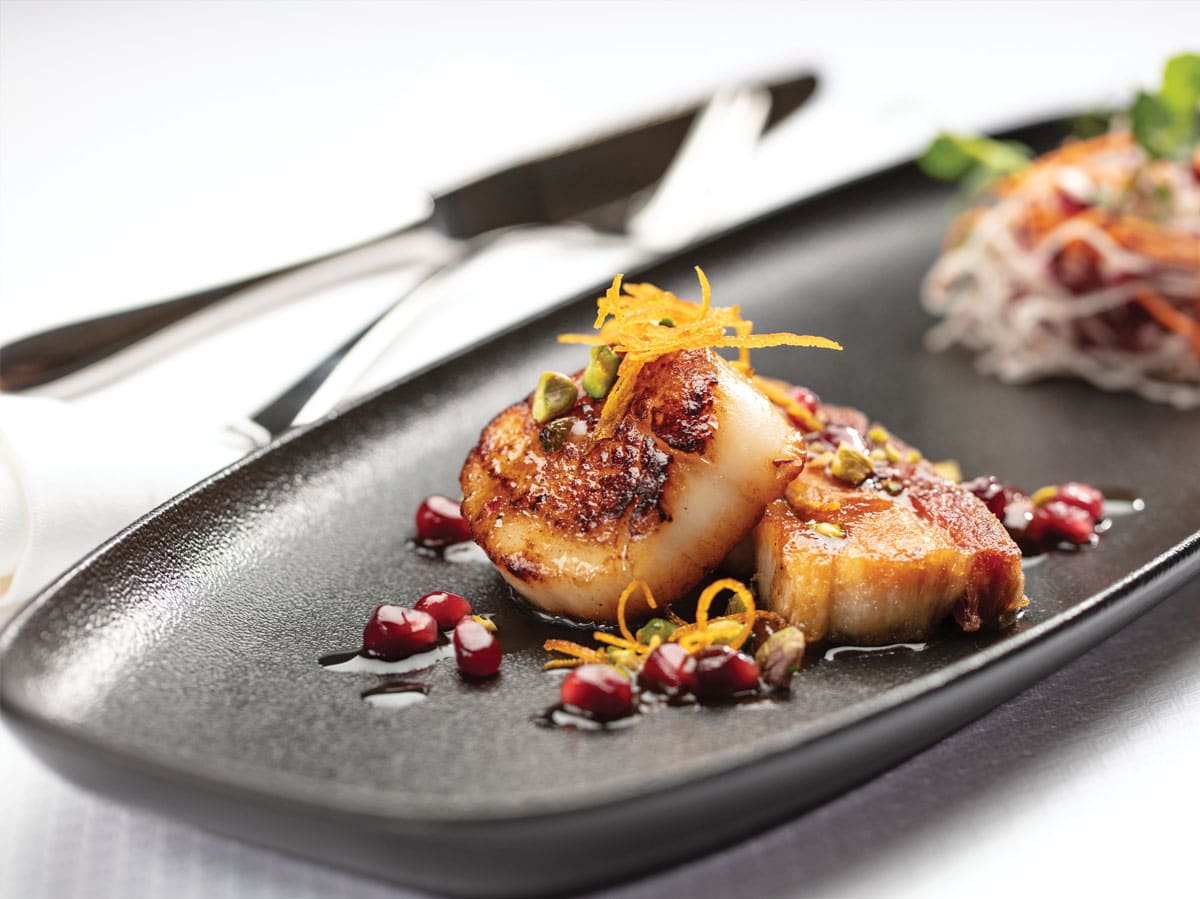 Seared Diver Scallop, Cured Pork Belly Confit, Orange Pomegranate Sauce