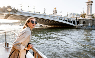 Woman riding ship near a bridge over the river