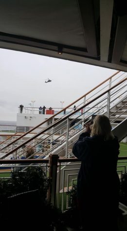 A CDC helicopter hovering above the Grand Princess