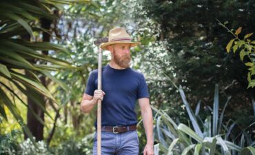 A man in a blue shirt and long beard
