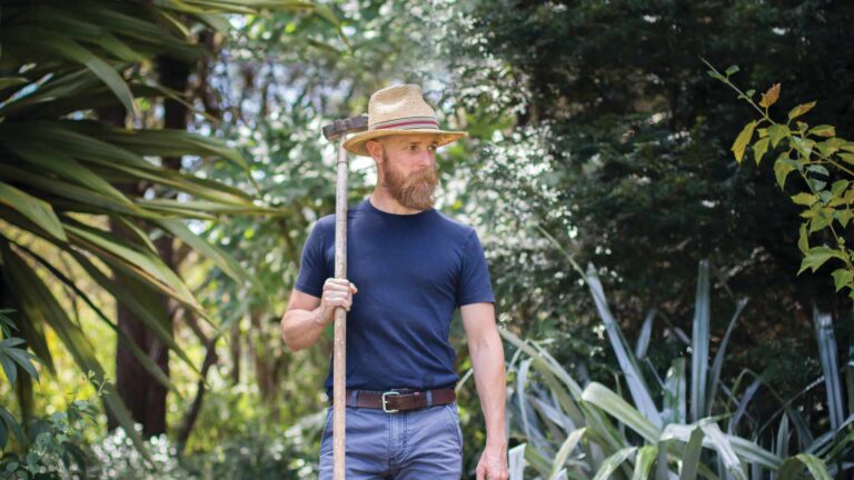 A man in a blue shirt and long beard