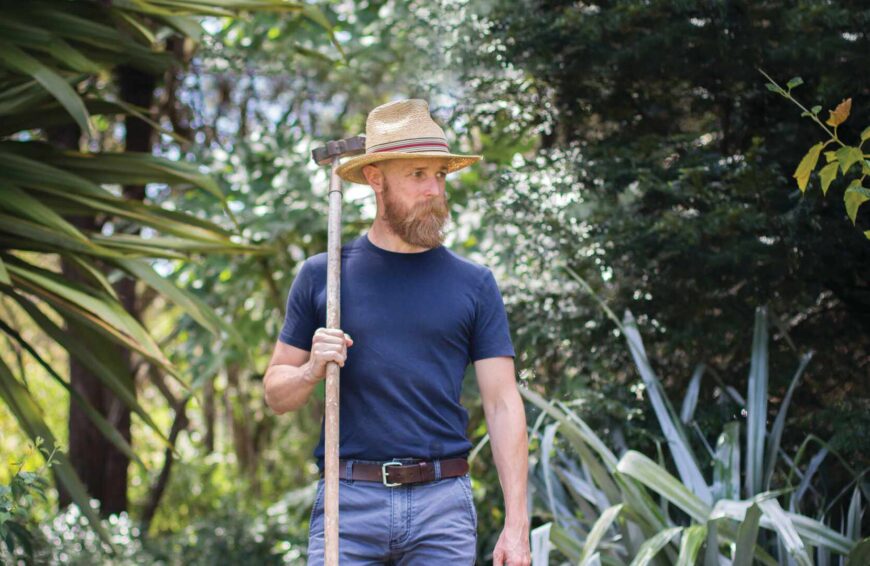 A man in a blue shirt and long beard