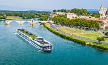 Cruise ship beside a scenic town