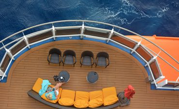 Woman alone reading her book on her cruise