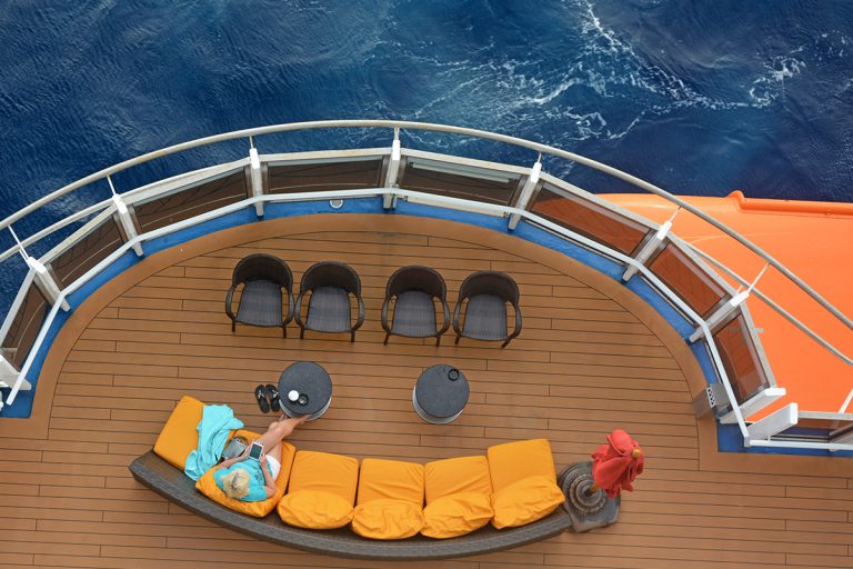 Woman alone reading her book on her cruise
