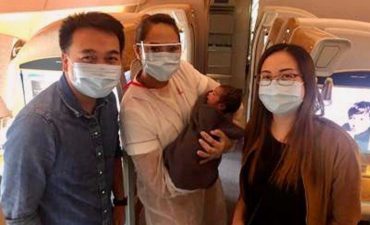 Nurses John and Christine Anne after they delivered a baby girl