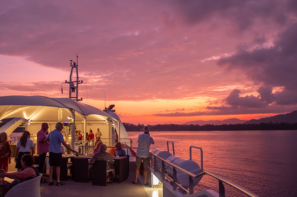 Guests admiring the sunset on the Coral Discoverer
