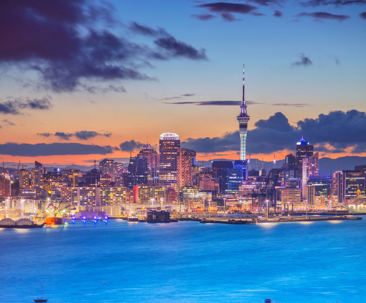 Cityscape image of Auckland skyline, New Zealand during sunset with the Davenport in the foreground.