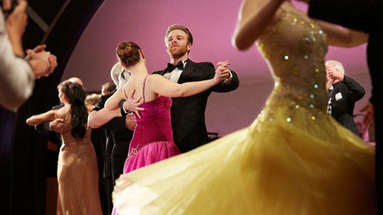 Cunard ballroom dancing couples twirl the night away.