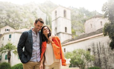 Couple with old building in the background