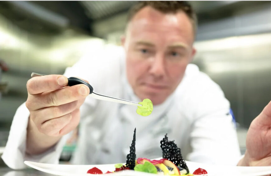 A chef holding an ingredient on Riverside ship