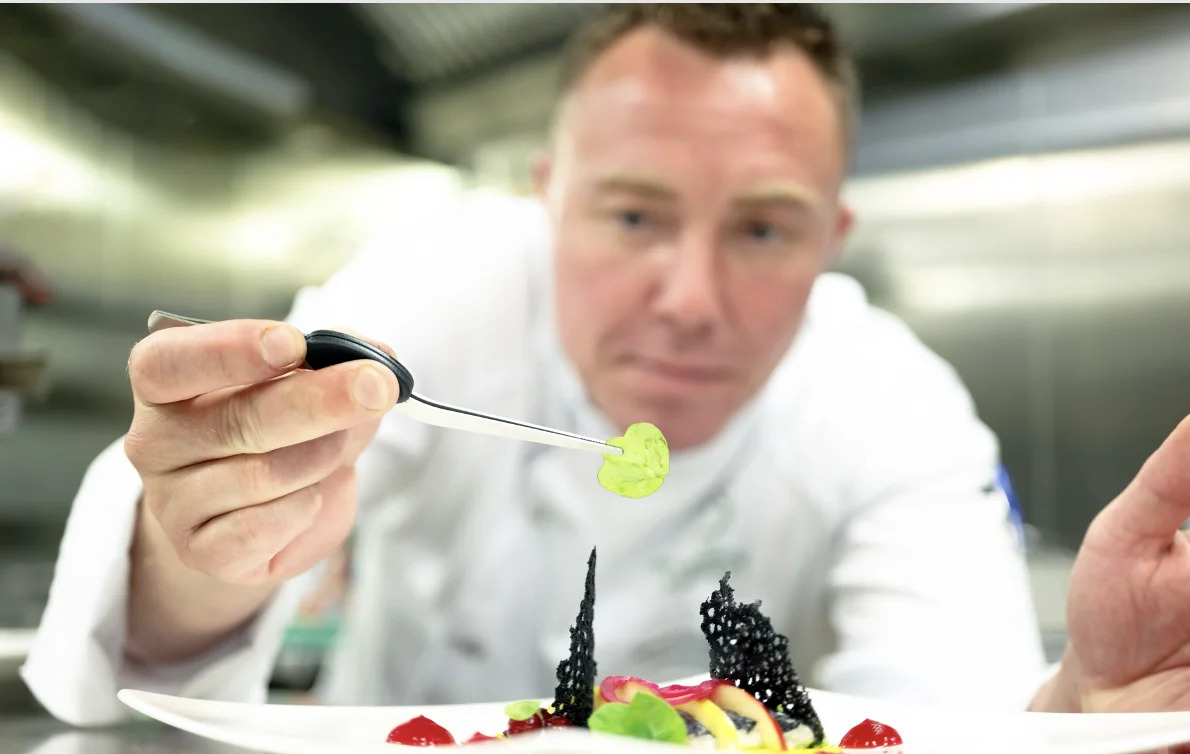 A chef holding an ingredient on Riverside ship