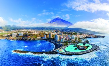 Aerial view with Puerto de la Cruz, in background Teide volcano, Tenerife island, Spain