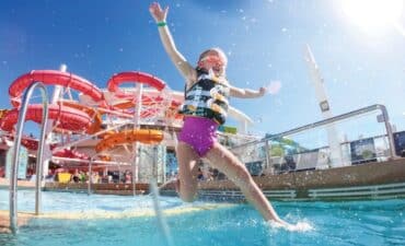 child jumping into a pool on board Wonder of the Seas