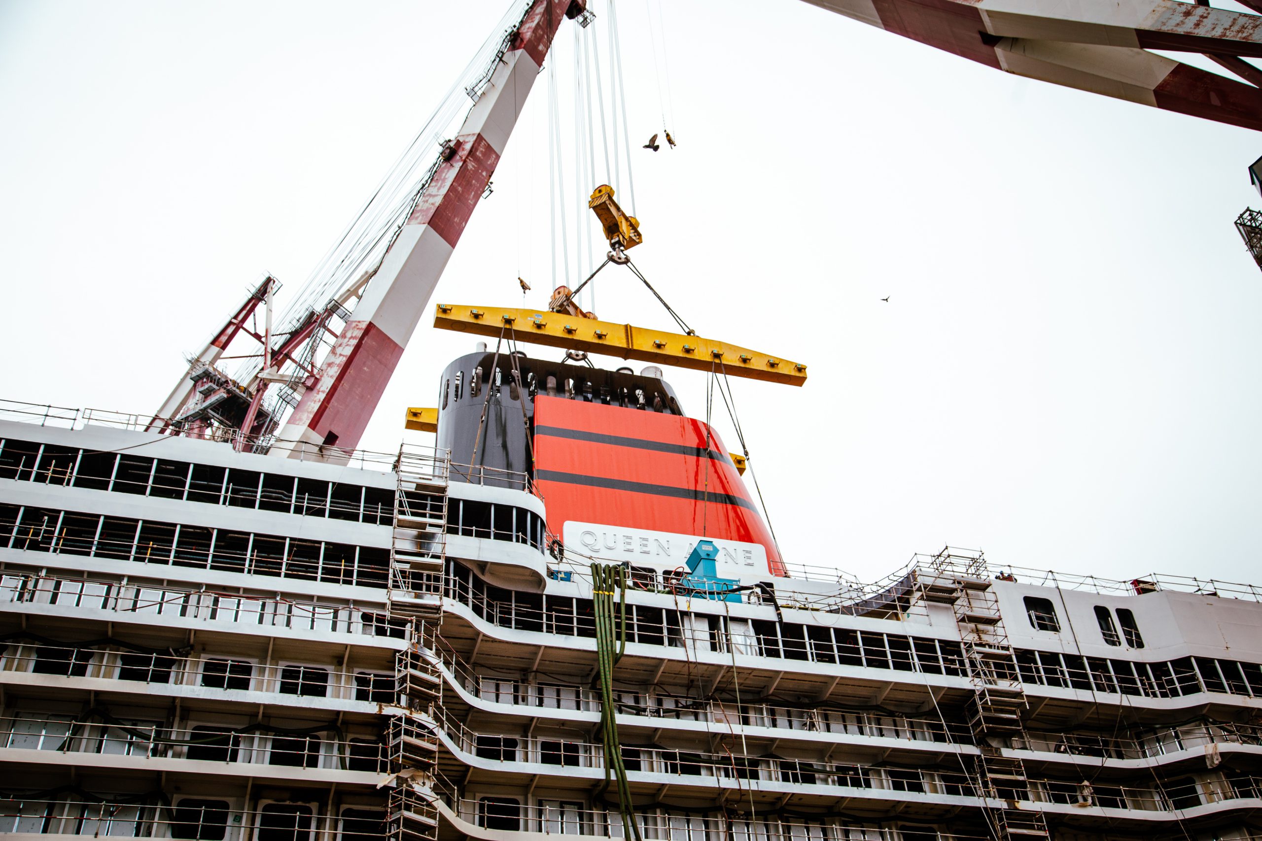 Queen Anne dons her iconic red and black funnel as construction progresses