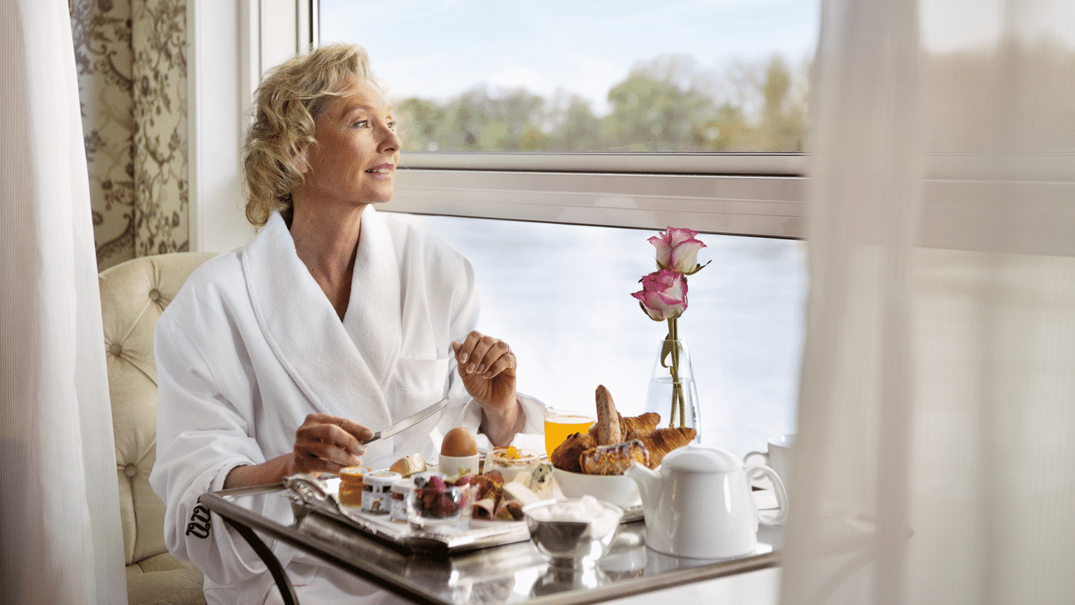 A woman enjoying breakfast onboard a Uniworld ship