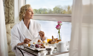 A woman enjoying breakfast onboard a Uniworld ship