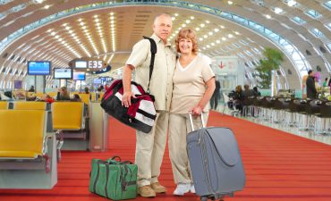 Senior Couple With Bags At Airport