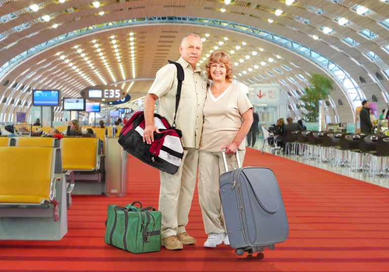 Senior Couple With Bags At Airport