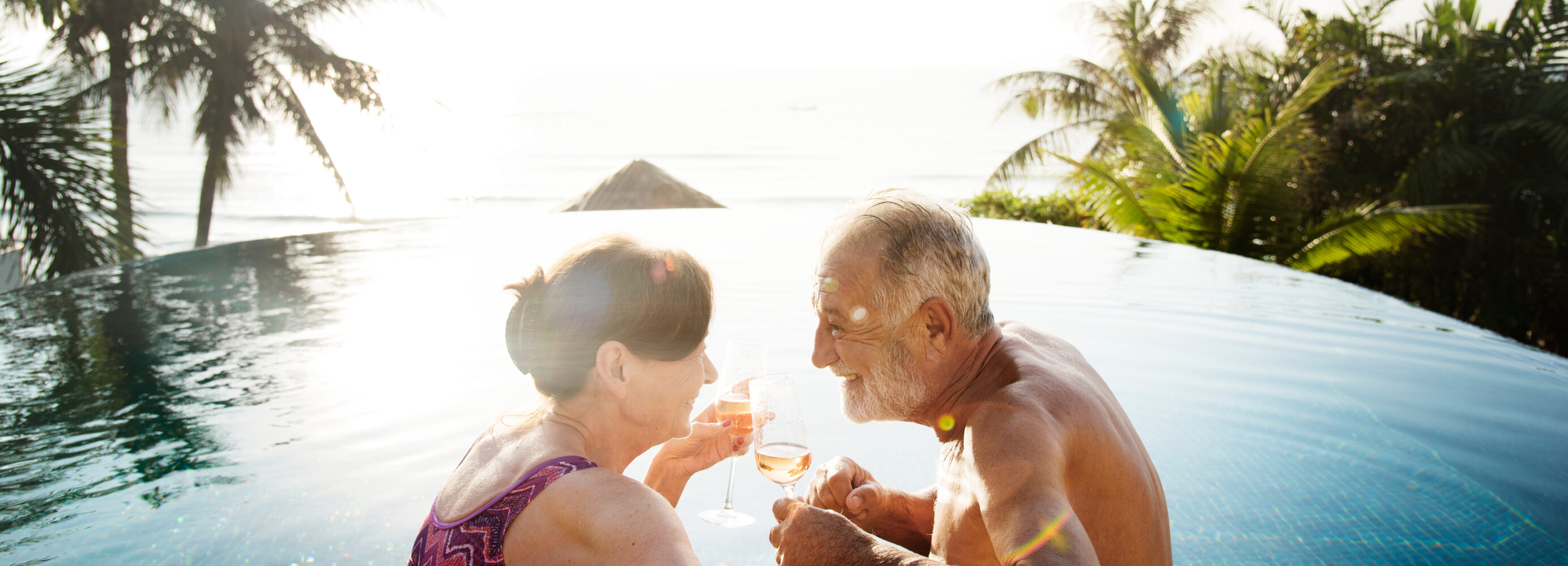 Elderly Couple in Pool with Wine