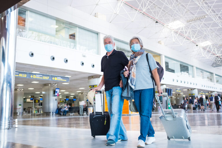 Couple of two seniors walking in the airport