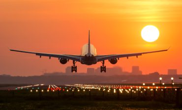 Passenger Plane Is Landing During A Wonderful Sunrise