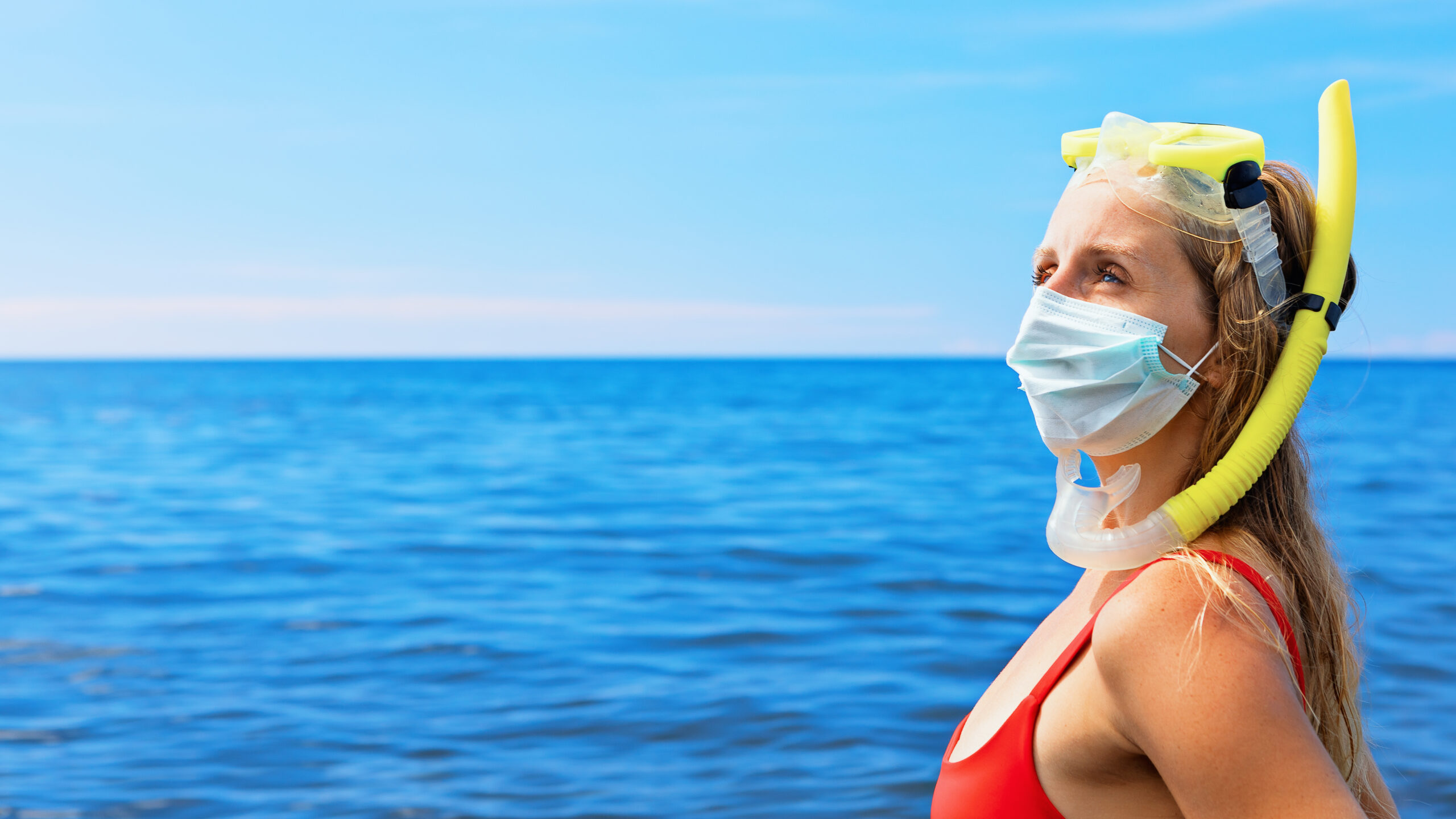 Girl in snorkeling mask wearing surgical mask