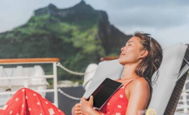 Tourist reading a book in a cruise ship