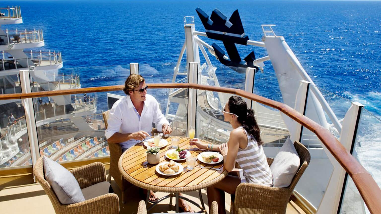 A couple enjoys a meal via Royal Caribbean ship.