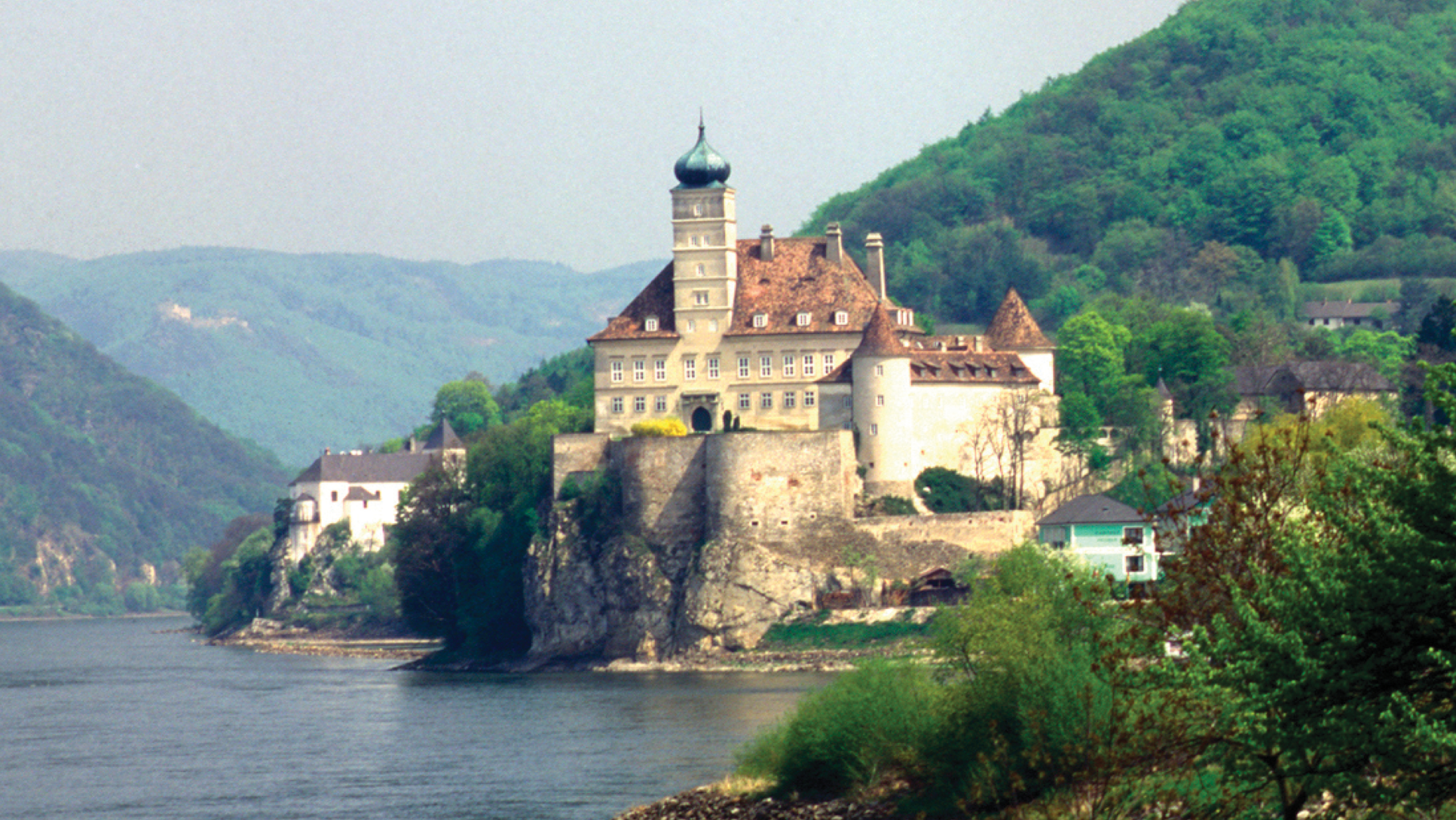 A view of the Danube River cruise with a castle