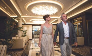 A couple walking through the atrium on Regent Seven Seas