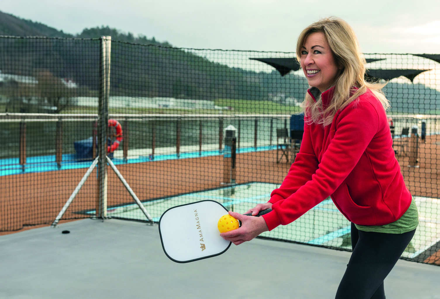 A woman plays pickleball on the deck of AmaMagna.