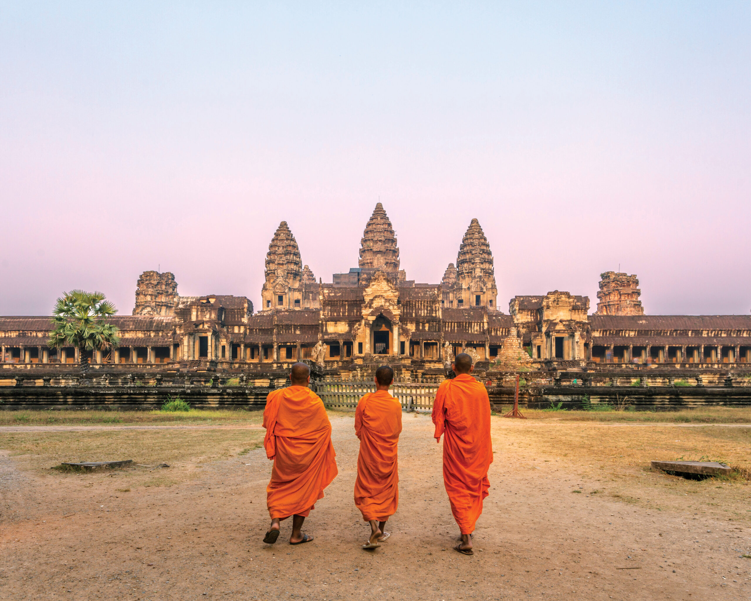 Three monks in front of Angkor Wat in Cambodia on an Avalon Waterways itinerary