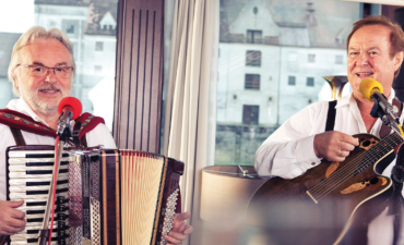 Two accordian players performing as one of the entertainment offerings on an APT ship