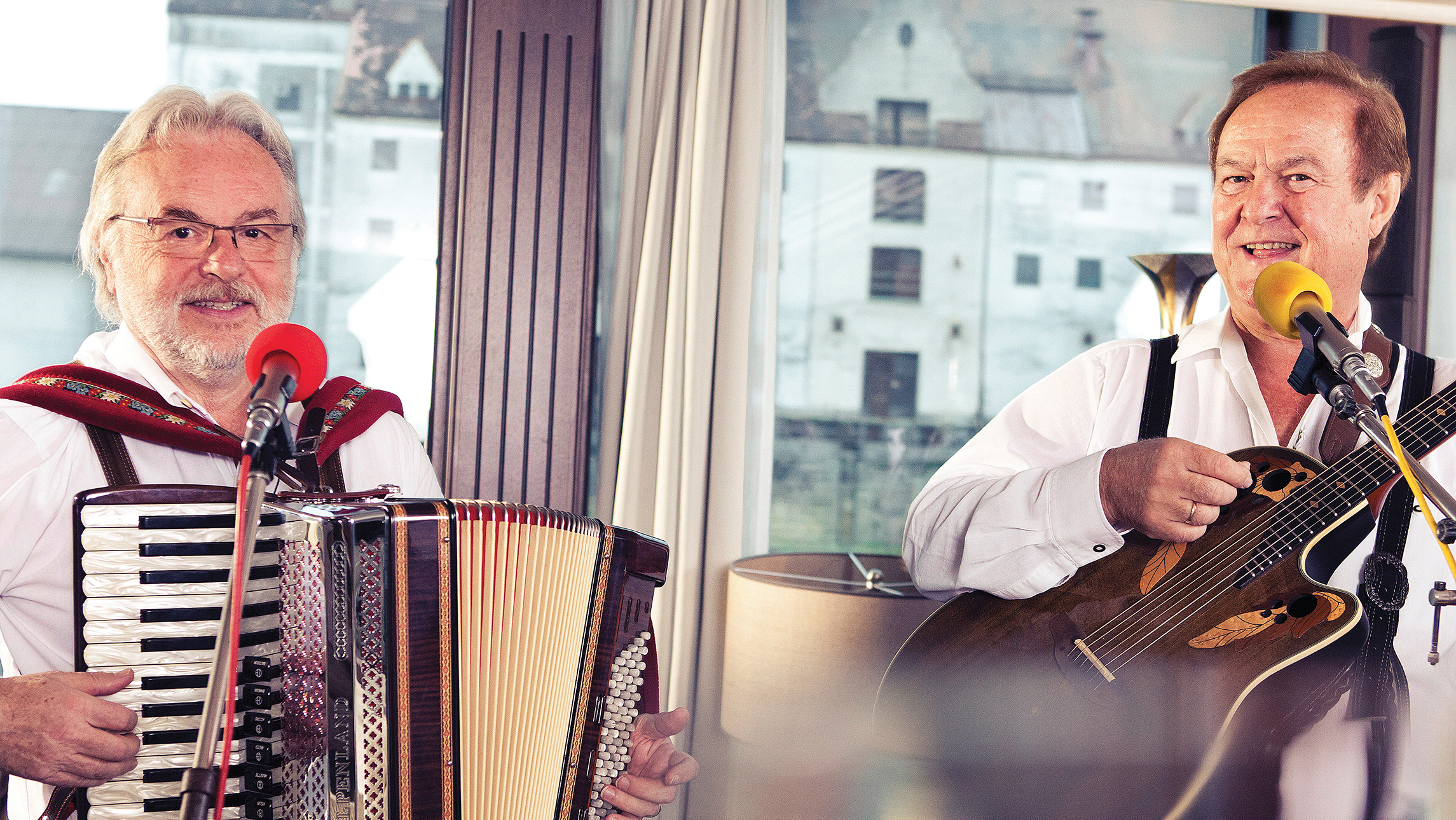 Two accordian players performing as one of the entertainment offerings on an APT ship