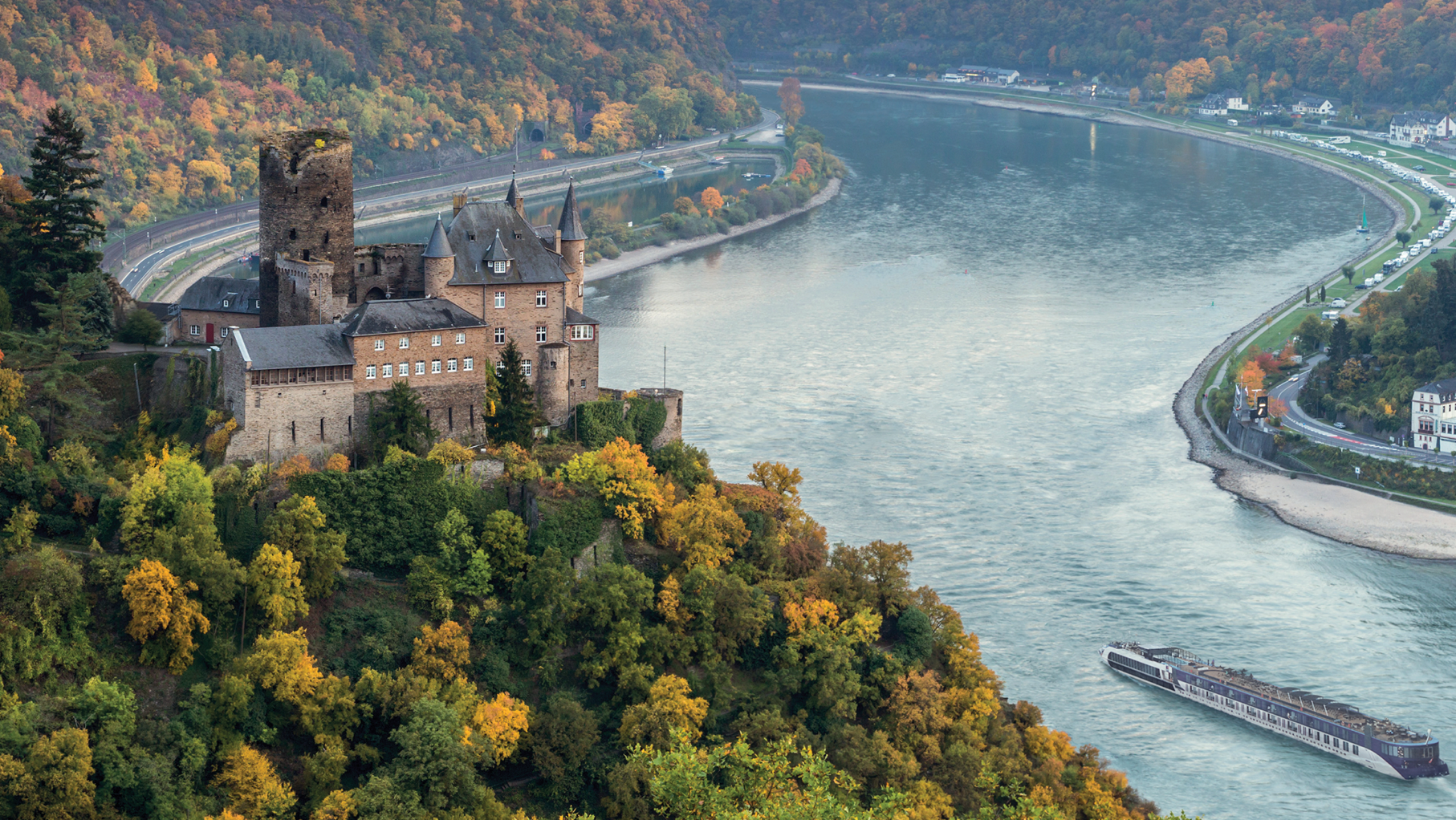 An APT ship sailing down the Rhine with a castle and forest