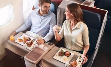 Two people on a Turkish airline flight enjoying a meal