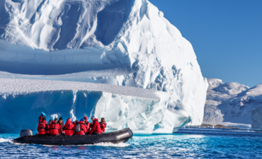 A group of Viking Expedition passengers in front of a glacier
