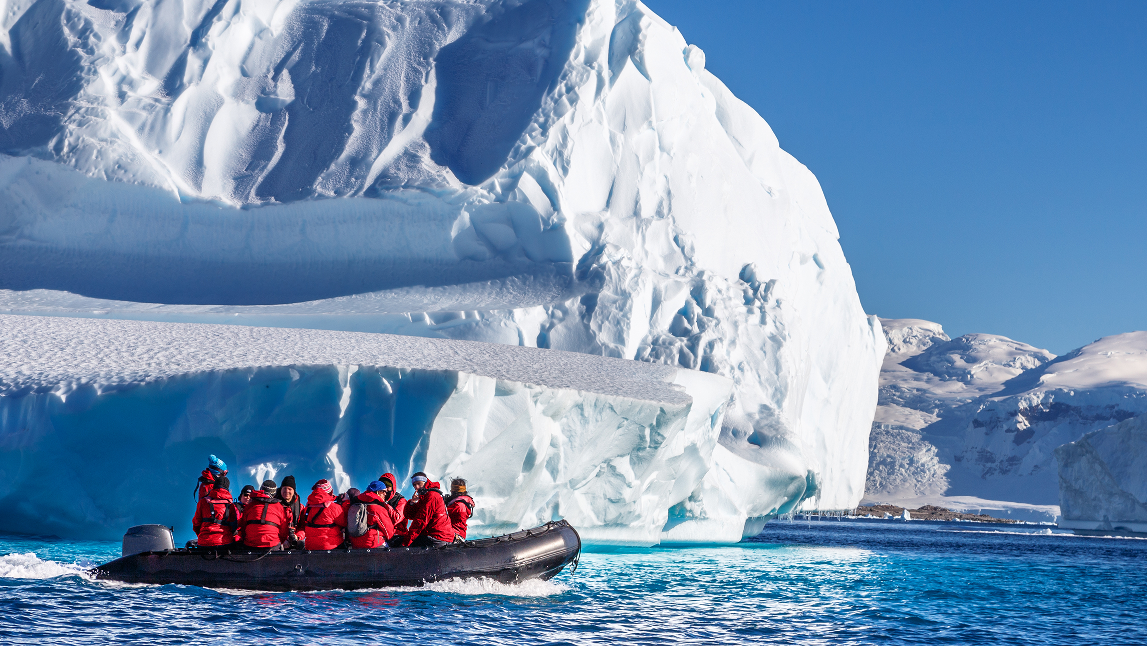 A group of Viking Expedition passengers in front of a glacier