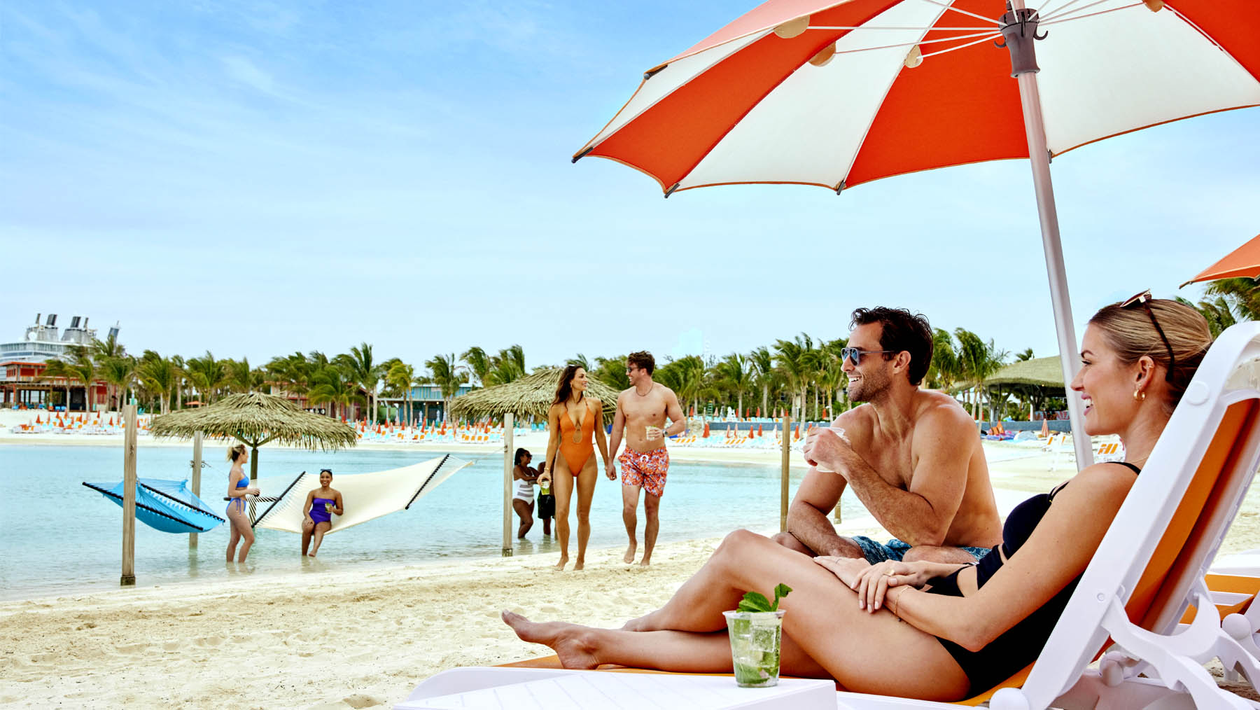 Celebrity Cruises guests enjoy the white sand beach At Perfect Day at CocoCay. 