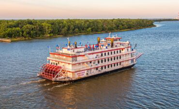 American Queen Voyages paddle steamer sailing on the river